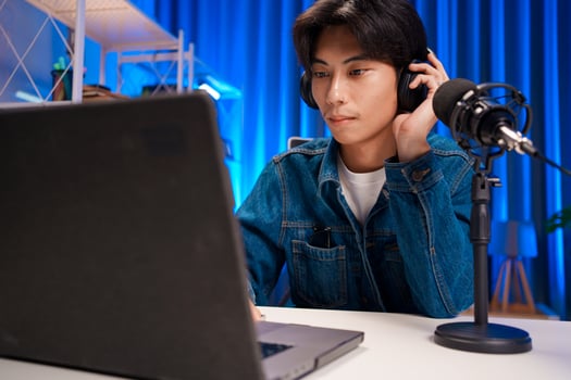 Man Listening Through Headphones in Podcast Setup photo