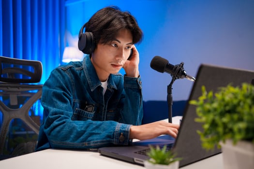 Podcaster Working on Laptop During Session photo