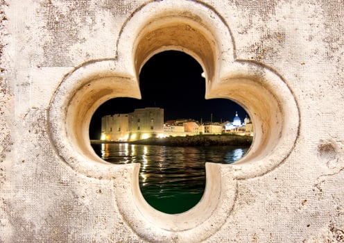 Night view of the Old Town Dubrovnik Through Stone Window View photo
