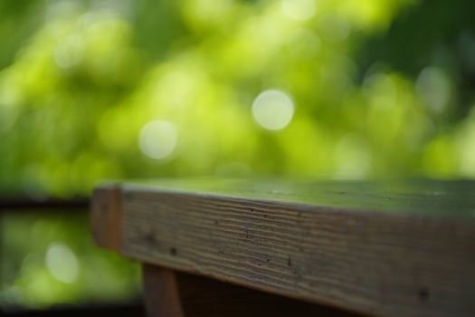 Nature Background Rustic Wooden Tabletop Outdoors with Blurred Green Spring Background Nature Setting photo