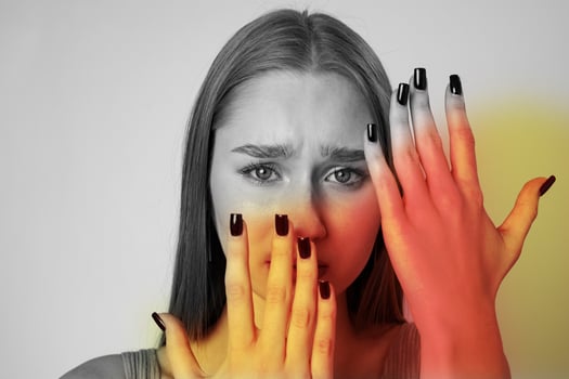 Expression of emotion with contrasting hands and face in muted colors photo