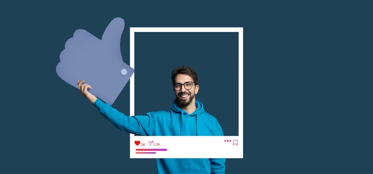 A cheerful content creator wearing a blue hoodie gives a thumbs up gesture in front of a dark background. photo