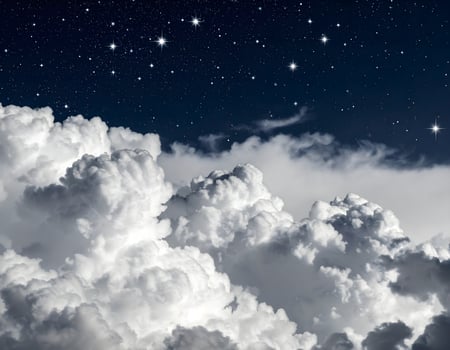 Stars shining over beautiful white clouds at night photo