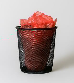 Red plastic bag in a black mesh trash can. photo