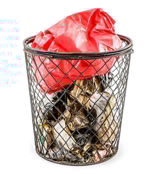 Full trash bin with red plastic bag. photo