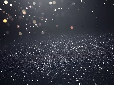 Dark background speckled with glittering particles. photo