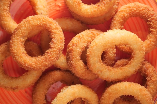 Crispy onion rings served in a vibrant bowl photo