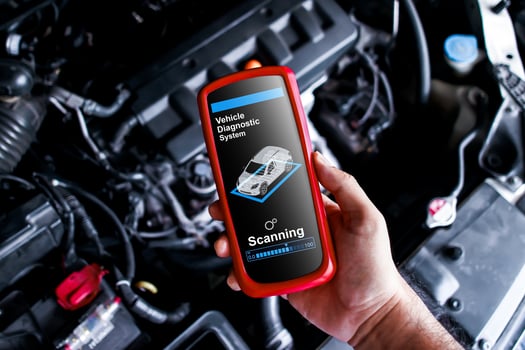 Vehicle Diagnostics Wireless Tool, A handheld device OBD2 scanner diagnostic for car repair by technician in auto service garage. photo