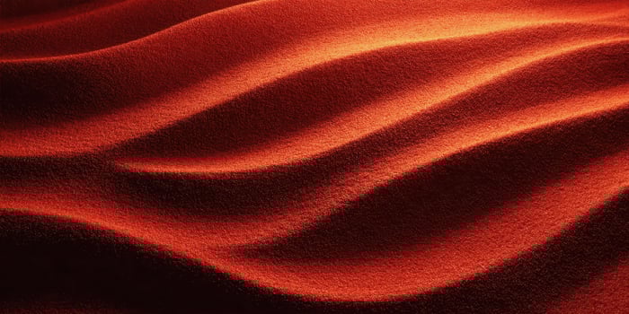 Close-up of Red Sand Dunes with Smooth Curves and Shadows photo