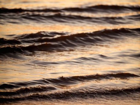 Golden Hour Macro Shot of Gentle Ocean Ripples photo