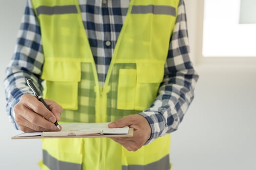 inspector or engineer inspecting construction and quality assurance new house using a checklist. Engineers or architects or contactor work to build the house before handing it over to the homeowner photo