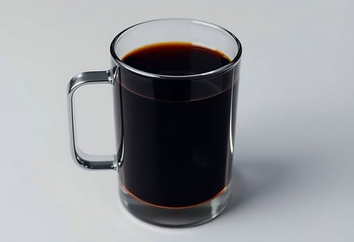 glass mug filled with liquid on top of a white table photo