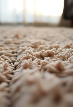 close up of a bed with a blurry background photo