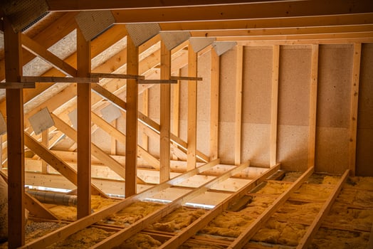 Attic Under Construction Showcases Wooden Beams and Insulation in a Residential Building photo