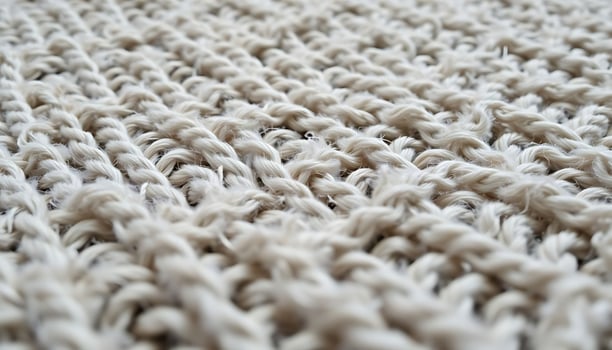 A close up of a white knitted rug photo