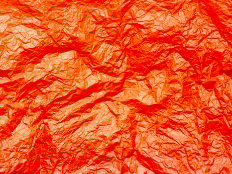 Crushed red paper texture, background photo