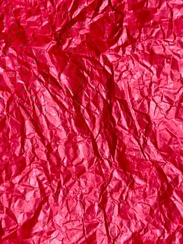 Crushed red paper texture, red background photo