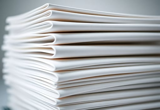 A stack of white papers on a table photo