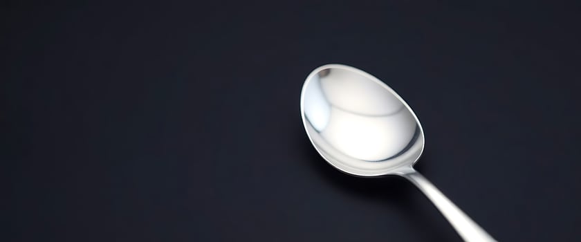 close up of a spoon on a black surface photo