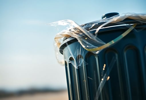 close up of a trash can with a plastic wrap around it photo