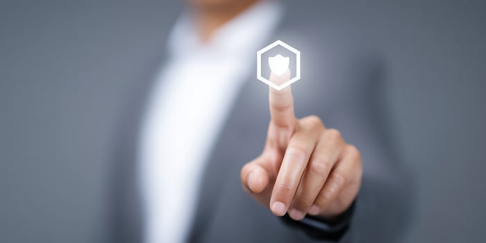 Business professional touching digital security icon on screen with blurred background showcasing technology and innovation concept photo