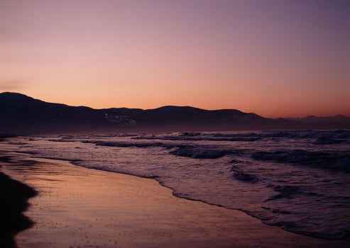 a sunset on the beach photo