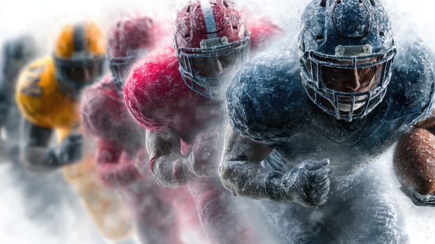 Exciting football players charging through snow during competitive match in winter season photo