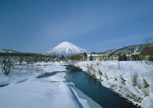 a river flowing through a snowy landscape photo