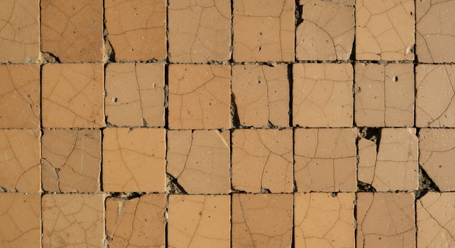 A close up of a wall with cracks in it photo