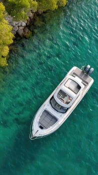 A white motor boat floating in the water near some trees photo