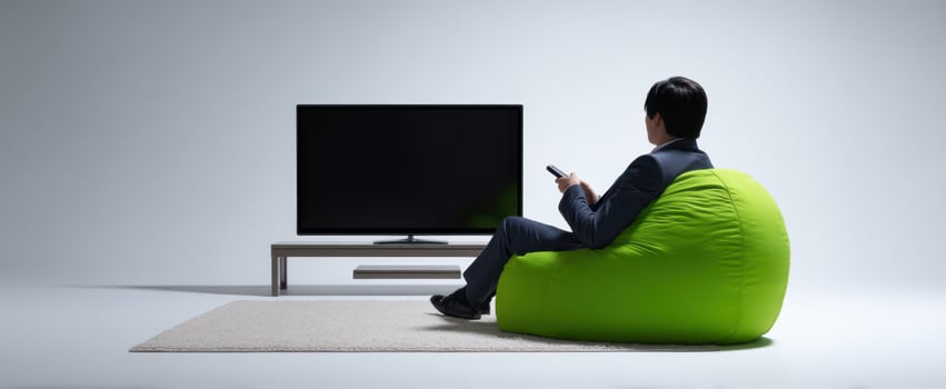 The comfortable man enjoying his leisure time watching television in a modern setting. photo