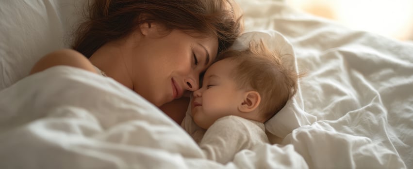 The intimate moment between a mother and her sleeping baby in bed. photo