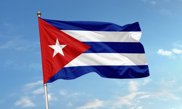 Cuban national flag with star waving under clear blue sky photo