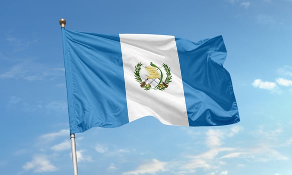 Guatemala national flag waving in wind photo