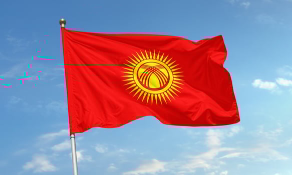 Kyrgyzstan national flag waving in sunlight photo