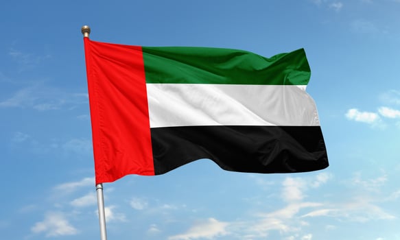 United Arab Emirates national flag waving in clear blue sky background photo