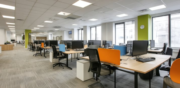Interior Office Space With Desks Black Chairs Monitors Under Bright Lighting photo