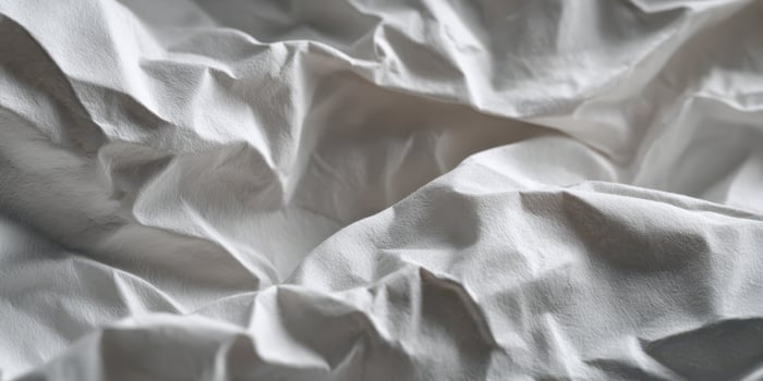 Close up of soft crumpled white fabric texture photo
