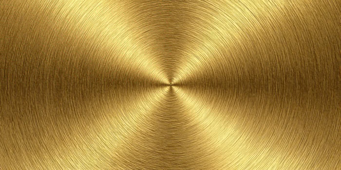 close up texture of brushed gold metal surface with circular pattern photo