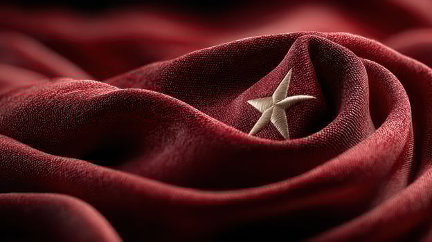 Red fabric with a star emblem symbolizes national pride and identity, showcasing intricate texture and deep color photo