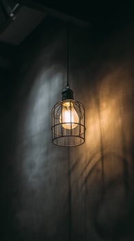 Elegant Hanging Light Fixture Adds Warmth to Modern Interior Space. photo