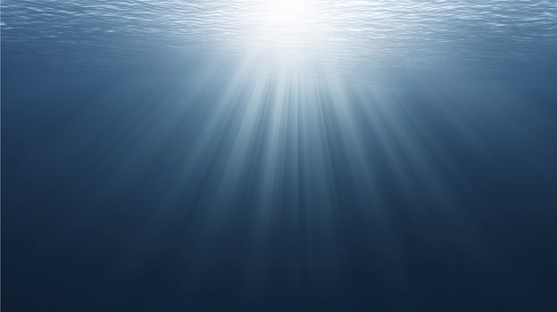 Underwater scene with sunlight rays penetrating the surface, creating a serene atmosphere, showcasing the beauty of aquatic environments and the tranquility of deep water photo