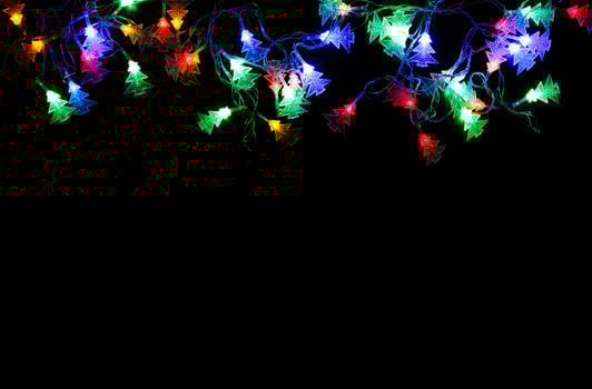 Christmas lights frame on black background. Holiday shiny garland border with copy space, top view. Xmas tree decorations, winter holidays illumination photo