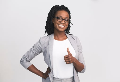 I Like It. Smiling African American Business Lady Gesturing Thumbs-Up Over White Studio Background. Isolated, Free Space photo
