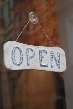 Store displays open sign on business hours photo