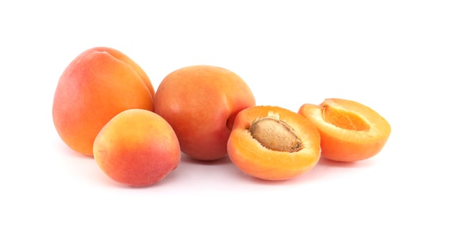 Vibrant apricots, whole and halved, showcasing their natural freshness and juicy texture. photo