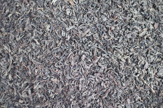 Dried tea leaves in bulk in natural lighting photo