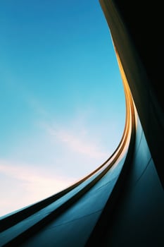 Abstract Geometric Architecture with Sky Above the Metallic Surface photo