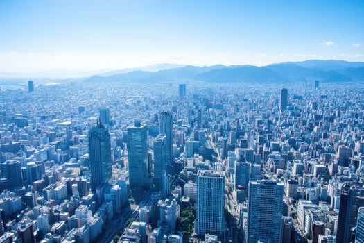 Cityscape Panorama from Above with Skyscrapers and Distant Mountains photo