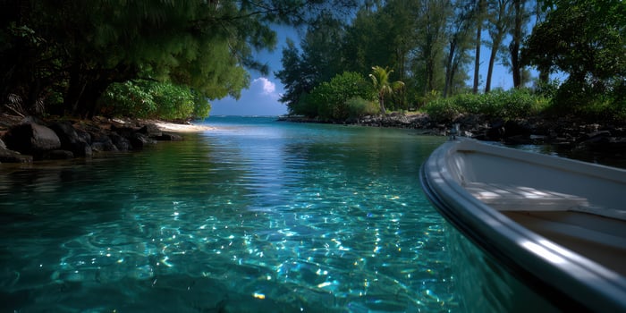 Clear turquoise water surrounds lush greenery in a tranquil tropical bay under a bright blue sky photo